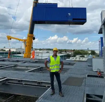 Amir in front of a generator