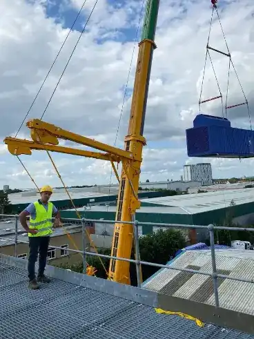 amir on the roof overlooking the crane picking up the generator